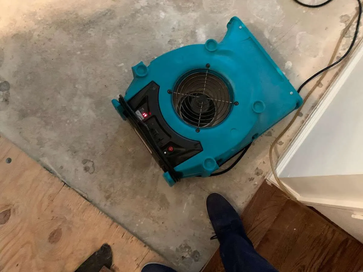 Air mover drying subfloor during Commercial Water Damage Restoration in Shelley